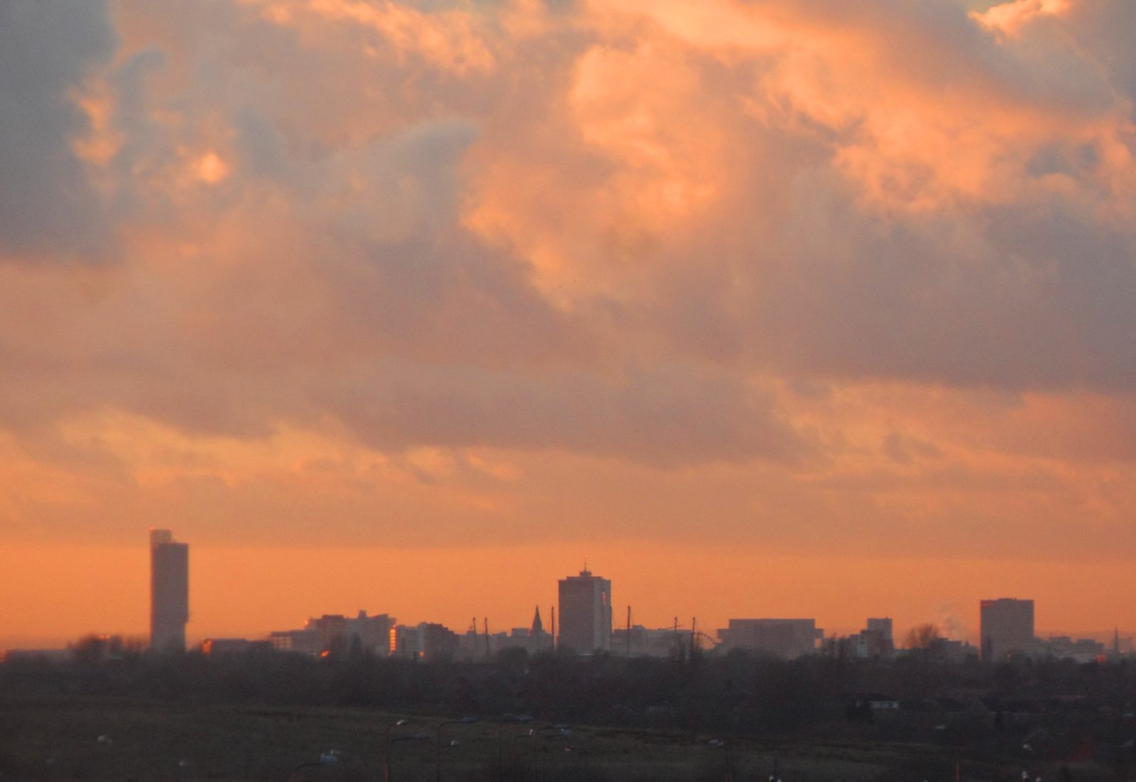 Manchester city centre skyline under a bright sky