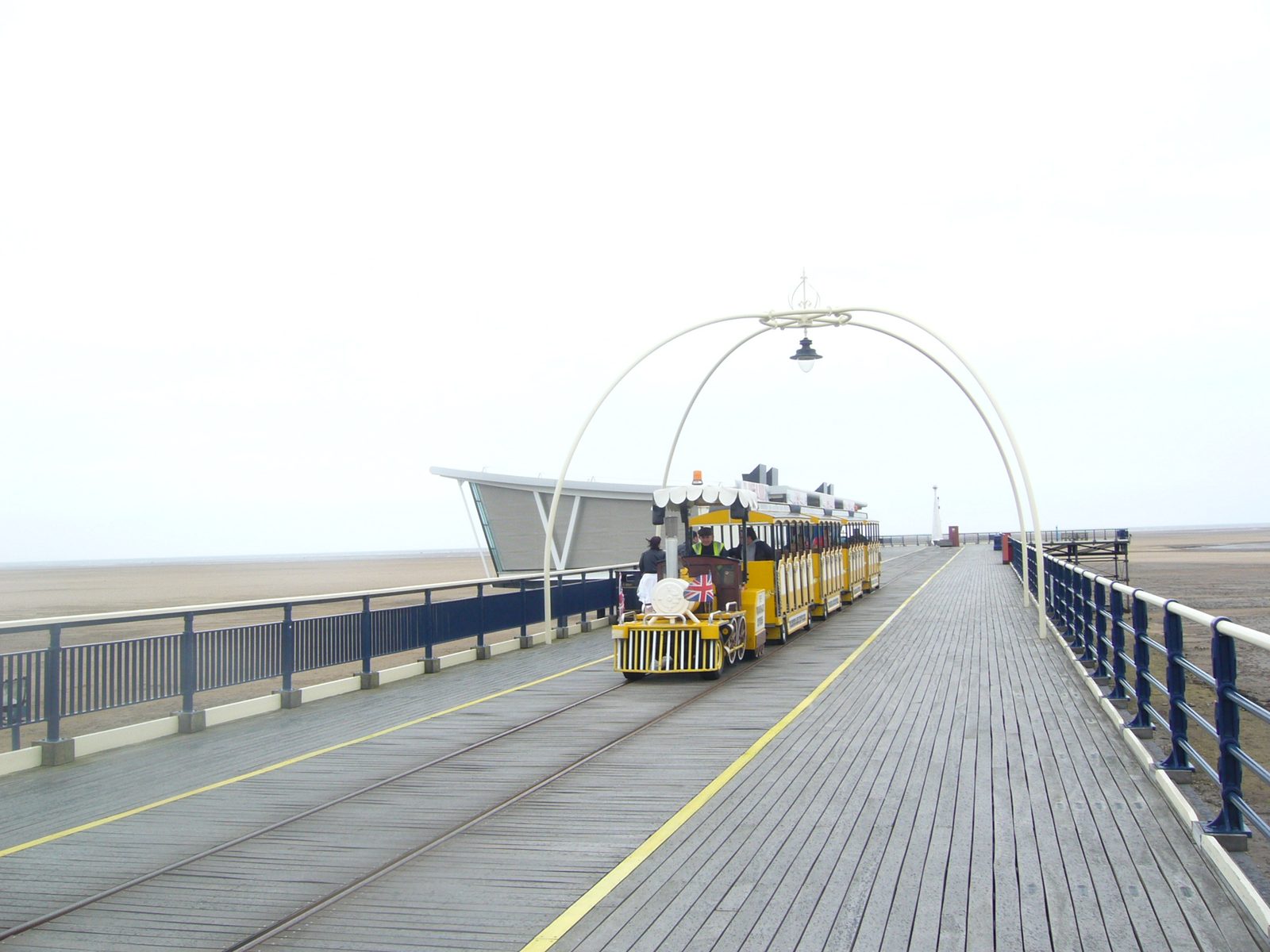 Long wooden pier at Southport over wet sand